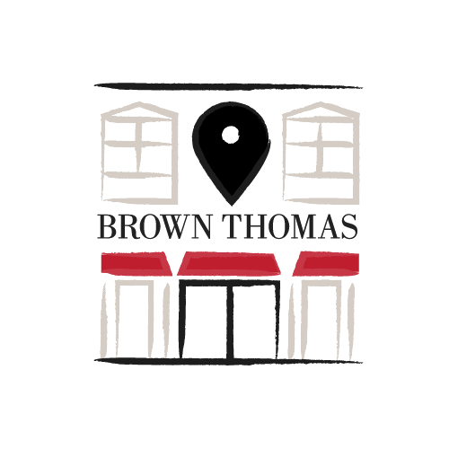 Stylized logo with red-roofed buildings, a map pin, and 'Brown Thomas' text.

